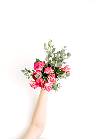 Woman hand hold rose flowers and eucalyptus bouquet. Flat lay, top view spring background.の写真素材