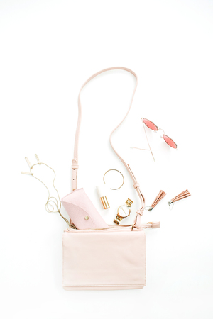 Woman fashion trendy accessories set: purse, sunglasses, watch, bracelet, necklace, lipstick, earrings on white background. Flat lay, top view stylish pastel pink concept.の写真素材