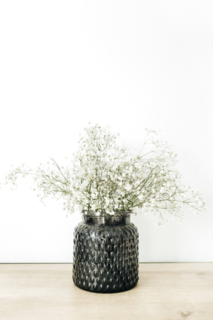 White gypsophila flowers bouquet in flowerpot at white background.の写真素材