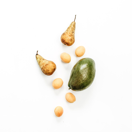 Seasonal fruits: mango, pears, apricots on white background. Flat lay, top view summer concept.の写真素材