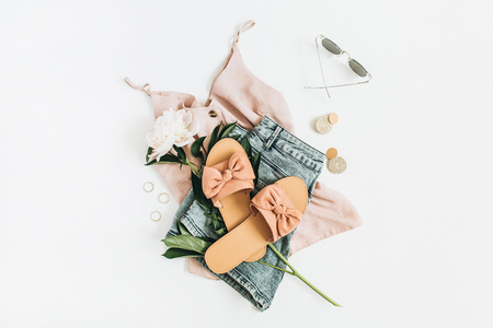Female fashion background with white peony flower, slippers, sunglasses, earrings, shorts, t-shirt. Flat lay, top view.の写真素材
