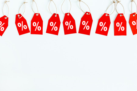 Black Friday sale discount concept. Red tags on white background. Flat lay, top view hero header.の写真素材