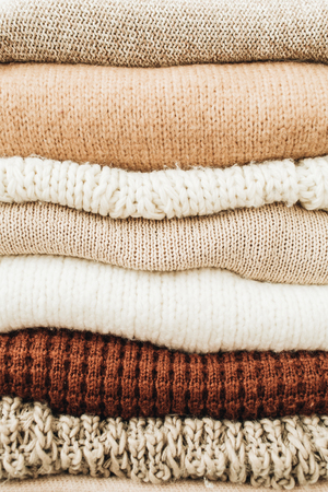 Closeup of warm winter sweaters and pullovers. Female minimal fashion clothes pattern.の写真素材