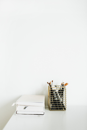 Notebooks, stationery on white desktop.の写真素材