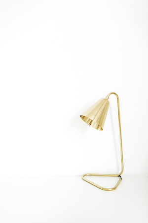 Golden lamp on white background. Minimal interior design concept.の写真素材