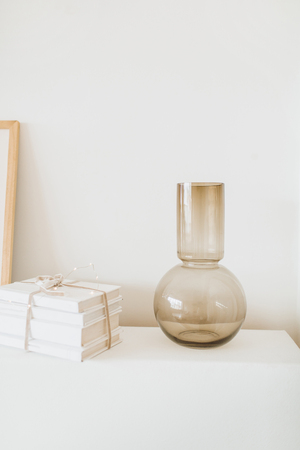 Gift box and vase on bright beige background. Minimal interior design concept.の写真素材