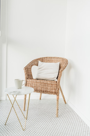 Rattan chair with pillow and marble coffee table at loggia with mosaic floor. Minimal modern Scandinavian nordic interior design concept.の写真素材