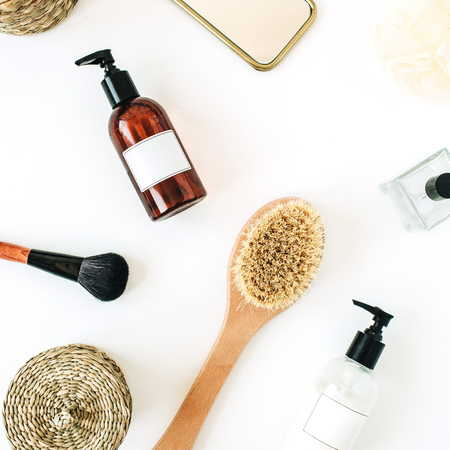 Spa, bath, skin care, beauty composition with brush, perfume, mirror, sponge, liquid soap, hand cream on white background. Flat lay, top viewの写真素材