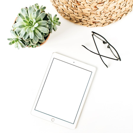 Minimalist home office desk with blank copy space mock up screen tablet, glasses, succulent on white...