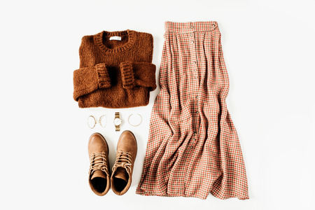 Fashion clothes look composition with brown sweater, shoes, skirt on white background. Flat lay, top view.の写真素材