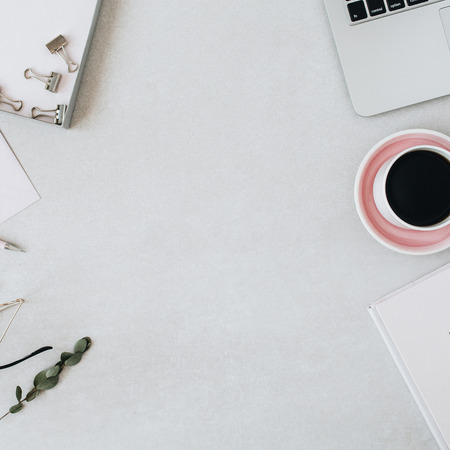 Round frame mockup with copy space. Home office desk workspace with laptop, coffee, notebook, eucalyptus, envelope. Flat lay, top view blog / website hero header template.の写真素材