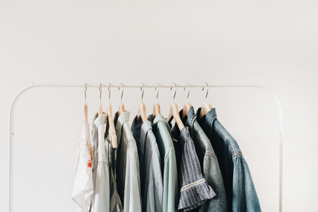 Minimal fashion concept. Female clothes on hanger on white background. Fashion blog, website, social media hero header.の写真素材
