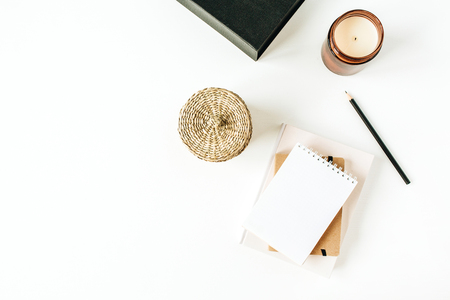 Minimalist office desk workspace with notebook on white background. Flat lay, top view blank paper copy space mock up.の写真素材