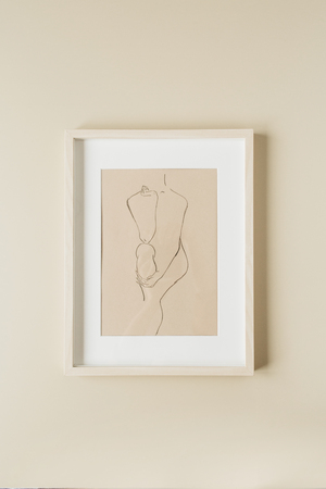 Minimal painting in photo frame on beige wall. Modern interior design concept.の写真素材