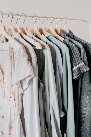 Feminine clothes on hanger. Minimal fashion composition on white background. Modern fashion blog concept.の写真素材