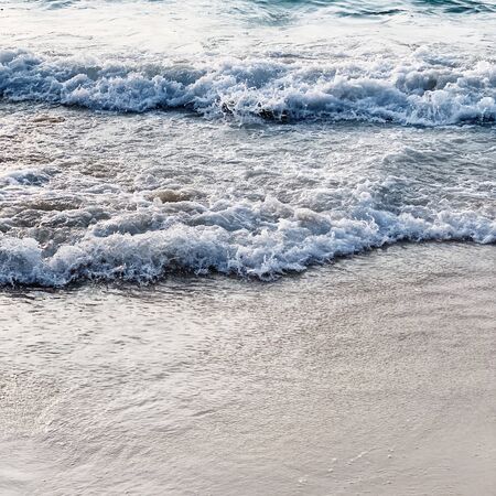 Beautiful tropical beach view with white sand and blue sea with waves on Phuket, Thailand. Minimal...
