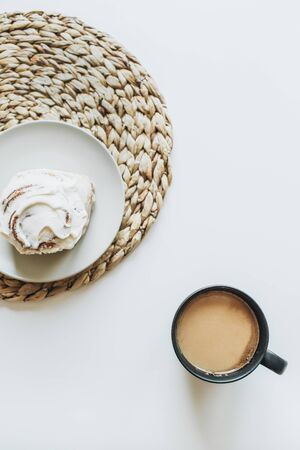 Morning breakfast with coffee and cake on white table. Flat lay, top view minimal food concept.の写真素材