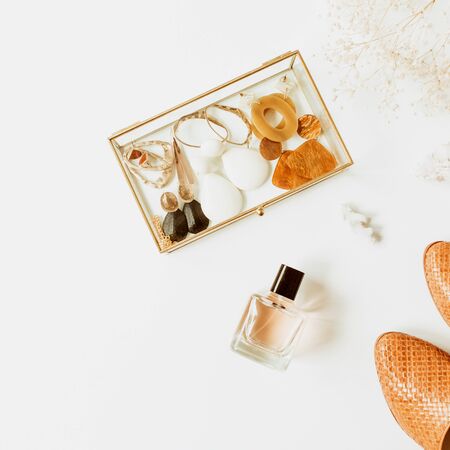 Feminine fashion composition with stylish accessories: leather shoes, earrings, perfume, flower bouquet on white background. Flat lay, top view trendy minimal lifestyle concept.の写真素材