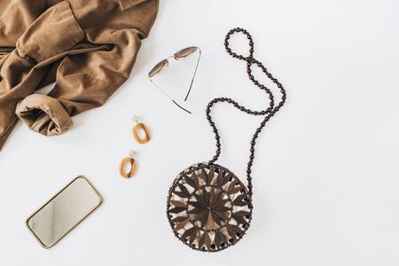 Modern fashion composition with women's clothes and accessories on white background. Shirt, purse, earrings, sunglasses. Flat lay, top view trendy lifestyle blog.の写真素材