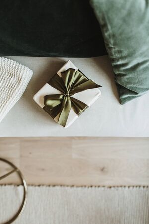 Small Christmas, New Year gift box and pillows. Festive winter holidays background. Flat lay, top view.の写真素材