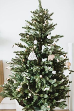 Christmas / New Year composition. Festive fir-tree decorated with toys, gifts, balls. Winter holidays concept.の写真素材