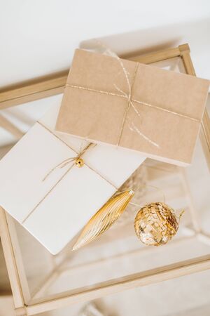 Christmas, New Year background with craft gift boxes and golden Christmas balls. Minimal winter holidays festive composition.の写真素材