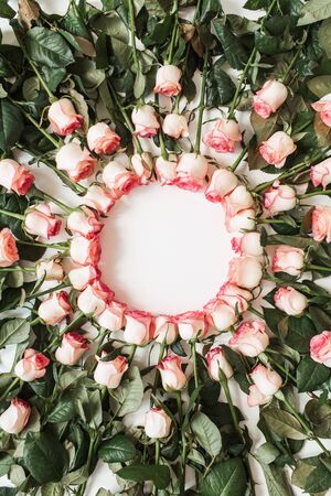 Frame with blank copy space mockup made of pink rose flowers on white background. Flat lay, top view...