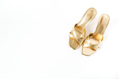 Flat lay golden women shoes on white linen. Top view minimal fashion blog background.の写真素材