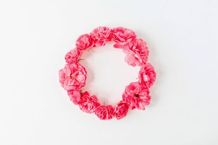 Round wreath frame border made of pink rose flowers. Flat lay, top view copy space mockup background.の写真素材