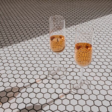 Cheers! Two glasses with rose champagne in sunlight shadows on mosaic tile. Happy Birthday, anniversary party holiday celebrating decoration festive conceptの写真素材