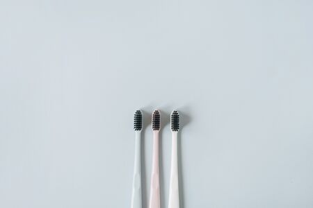 Toothbrushes on blue background. Flat lay, top view minimal oral care, dental hygiene concept