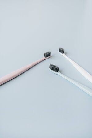 Toothbrushes on blue background. Oral care, dental hygiene concept.