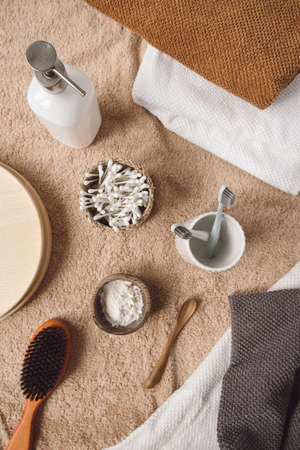 Flat lay beauty, spa, treatment, wellness composition with towels, toothbrushes, ear sticks, powder,...