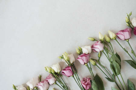 Flowers composition with many roses on gray background. Flat lay, top view festive holiday celebrationの写真素材