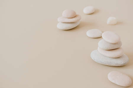 Pale pastel stones stack on neutral stones. Flat lay, top view minimal spa concept.の写真素材