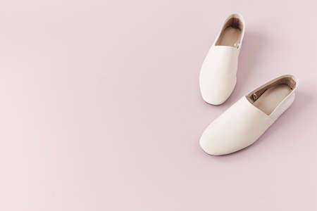 Fashion collage with women's white leather slippers on pink. Minimal lifestyle concept.の写真素材