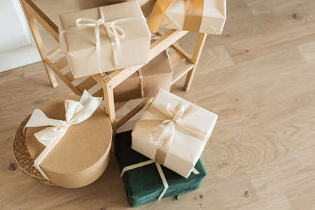 Homemade craft gift boxes with bow ties. Merry Christmas / Happy New Year holidays celebration...