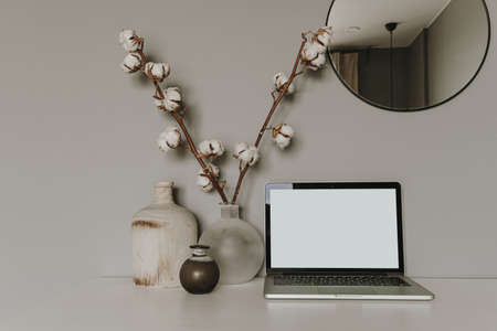 Blank screen laptop. Home office desk table workspace. Modern hygge interior design. Copy space...