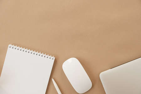 Minimal home office desk workspace on pastel beige background. Blank sheet notebook, laptop. Business template with copy space for blog, website, social media. Girl / Lady boss work concept.の写真素材