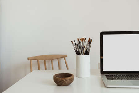 Blank screen laptop computer. Home office desk table workspace. Modern minimal Scandinavian interior design. Blog, magazine, web, social media template with copy space mockup.の写真素材