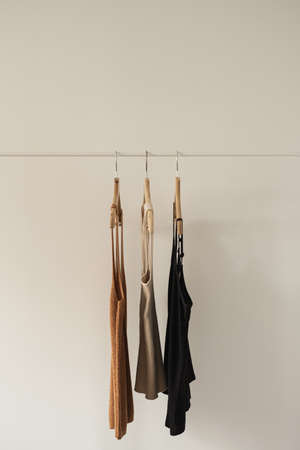 Aesthetic minimalist fashion influencer blog concept. Summer female tops, t-shirts on clothing rack...