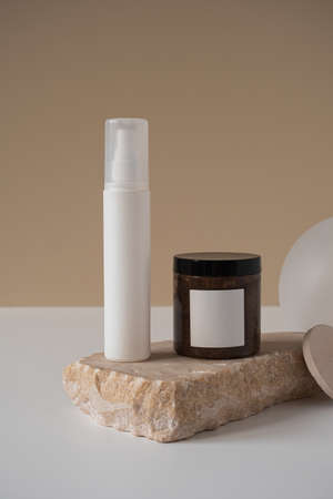 Blank spray bottle, body cream jar, marble stone on neutral pastel beige background. Aesthetic minimal beauty cosmetics composition with body care treatment. Organic natural spa therapy productの写真素材