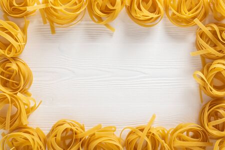 Dried pasta selection on wooden white background. Top view.の写真素材