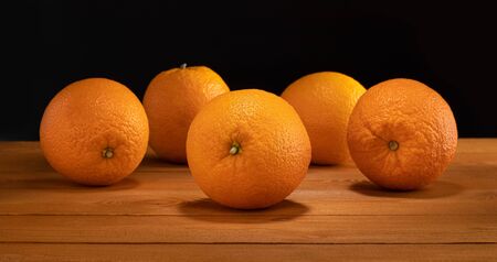 group of oranges on old rustic wood tableの写真素材