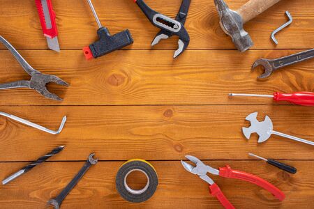Top view layout of tools for repair on wooden background, free space for textの写真素材