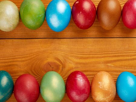 Colorful easter eggs on wooden background, free space for textの写真素材