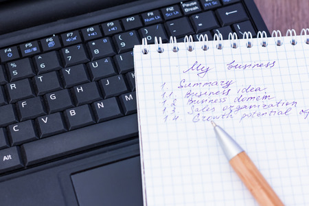 Business plan with notepad notebookの写真素材