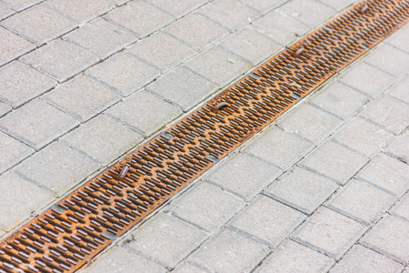 Water during a heavy rain runoff flows intoの写真素材