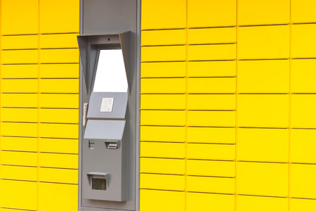 Self-service terminal in yellow facadeの写真素材