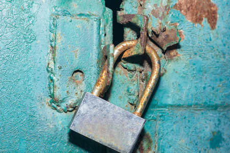 The padlock on the metal green door. Concept: safely, storage, securityの写真素材